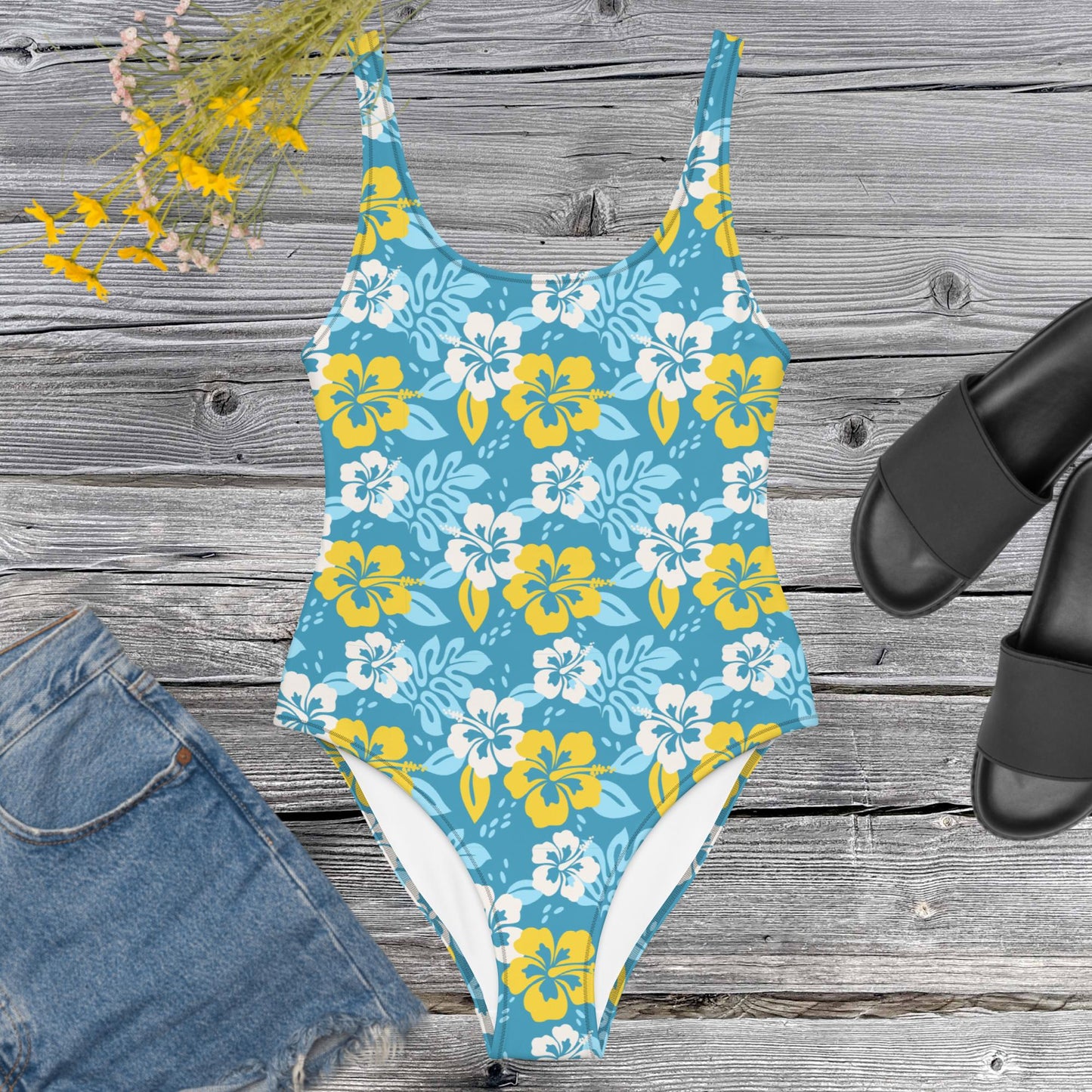 One piece all over print swimsuite with hawaian flowers on a blue background